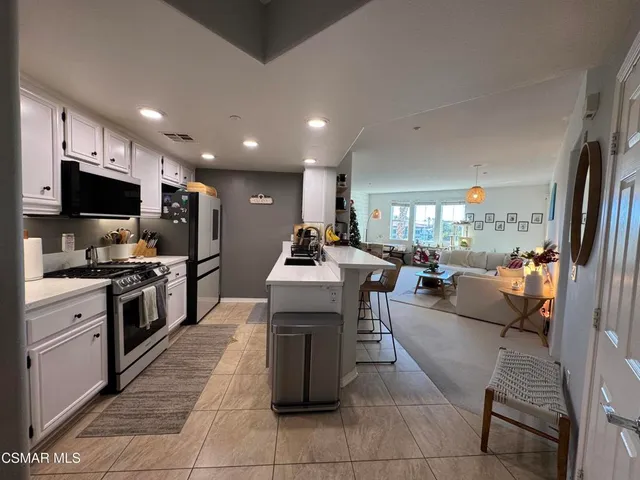 a kitchen that has a lot of cabinets and wooden floor