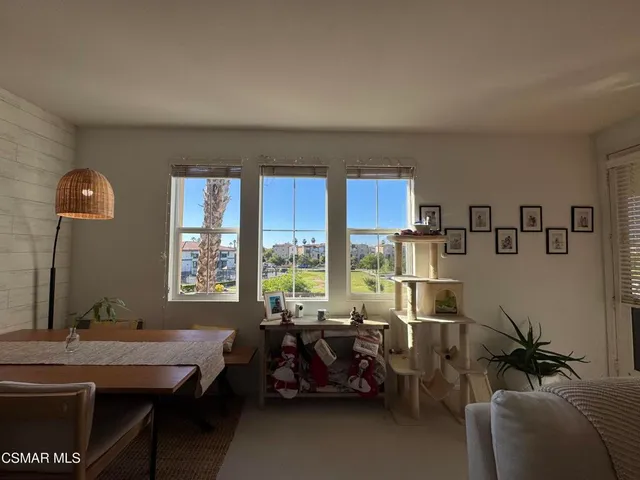 a view of a couches and dinning table and chairs in patio
