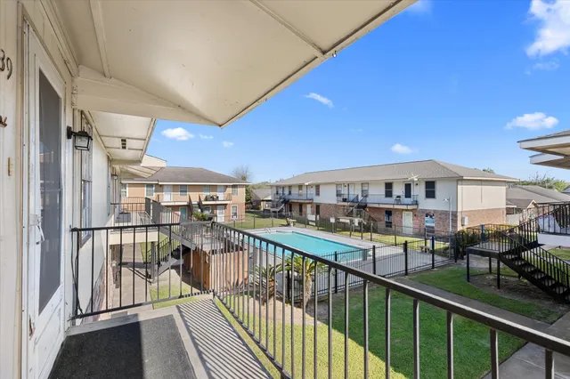 a view of a balcony with furniture