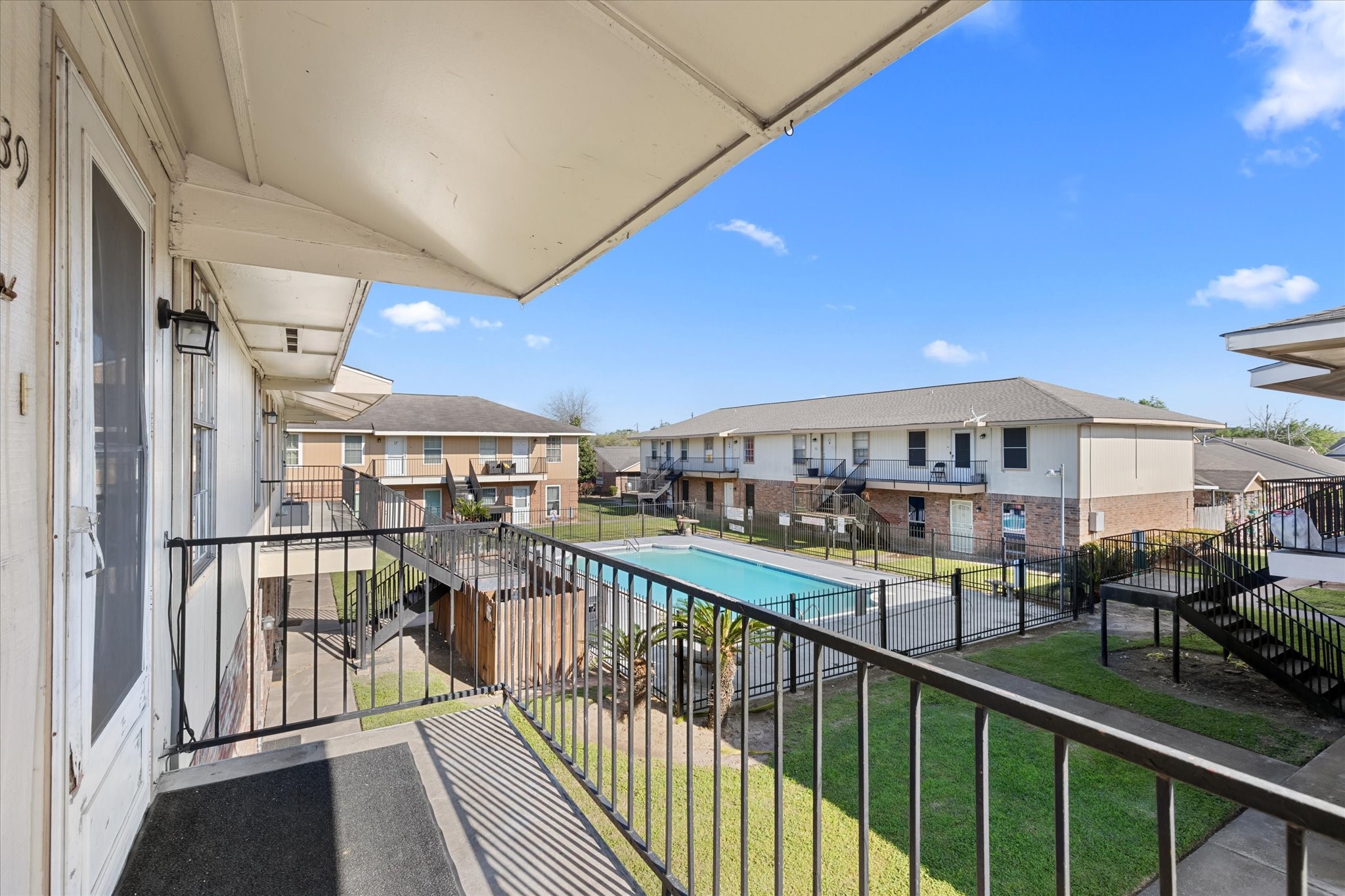 a view of a balcony with furniture