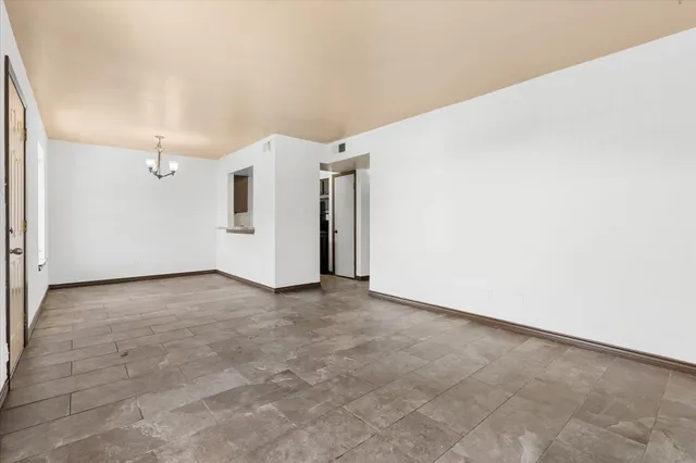 an empty room with windows and closet