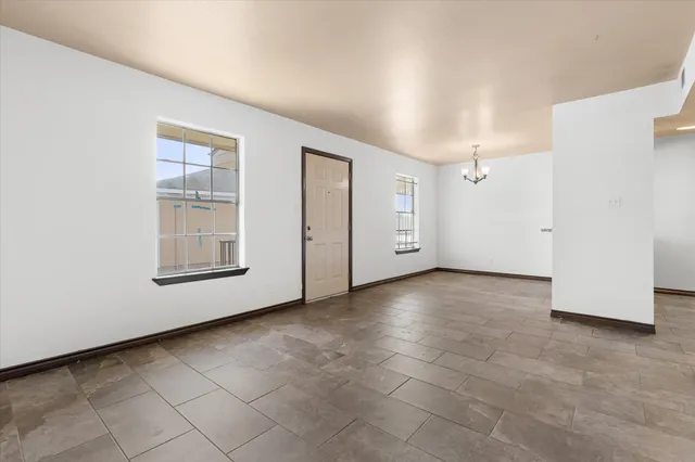 a view of a room with wooden floor and windows