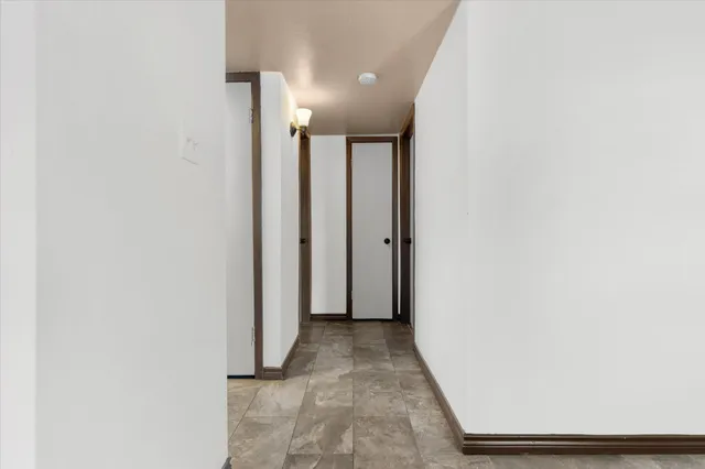 a kitchen with granite countertop a refrigerator and a sink