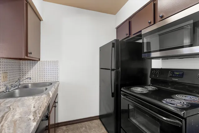 a view of a kitchen with a sink and dishwasher