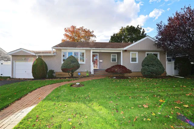 a view of a house with backyard sitting area and garden