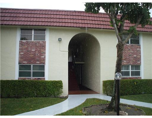 22775 Southwest 66th Avenue, Unit 1070 Boca Raton, FL 33428 - Photo 1 of 5 a front view of a house with garden