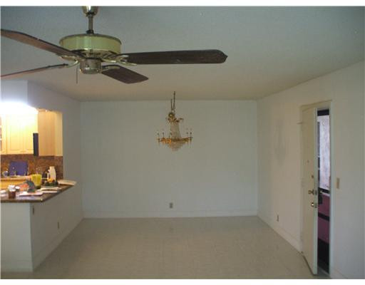 22775 Southwest 66th Avenue, Unit 1070 Boca Raton, FL 33428 - Photo 2 of 5 a room with a chandelier fan and a window