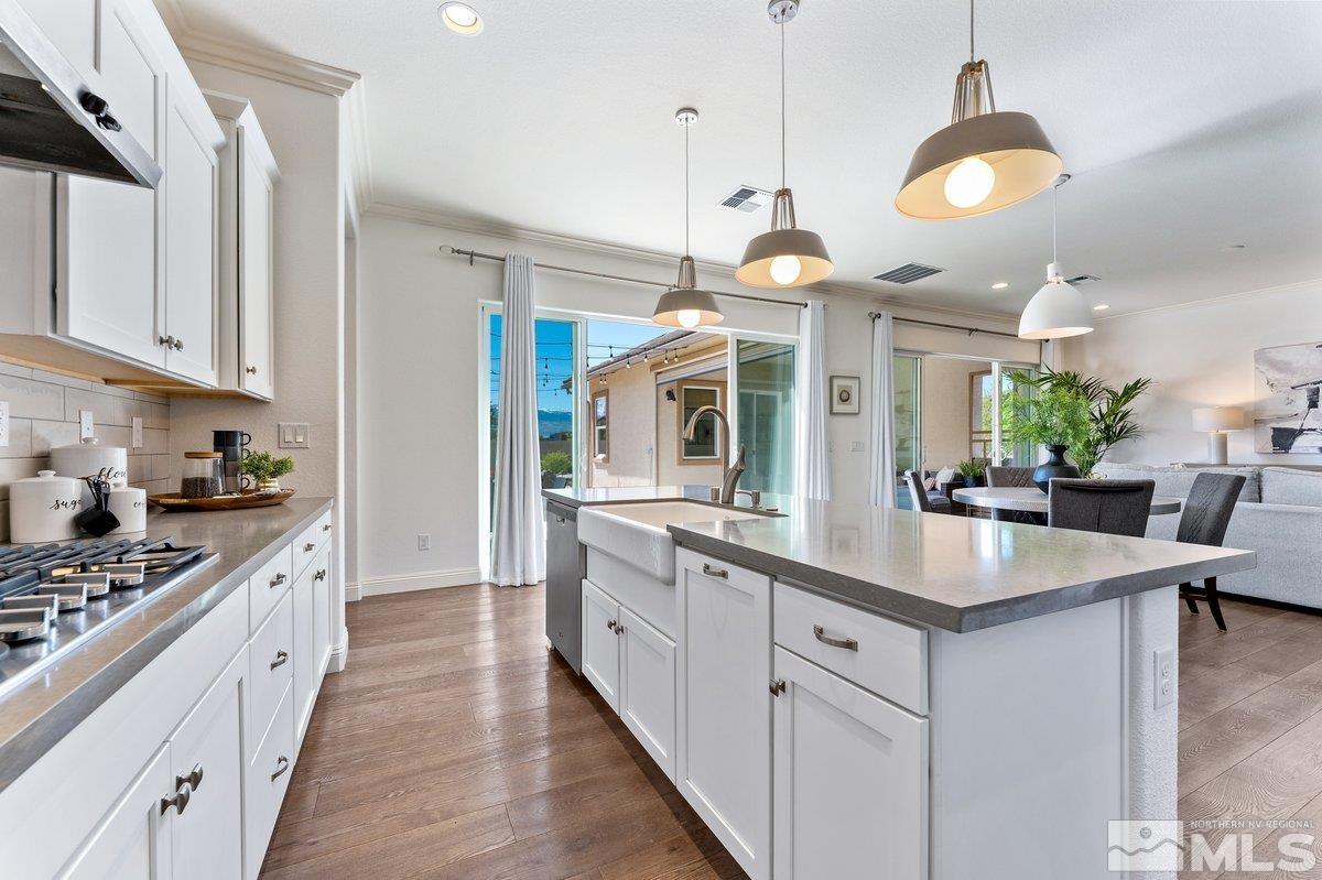 9815 Sea Bird Lane Reno, NV 89521 - Photo 12 of 40 a large kitchen with granite countertop a stove and a sink