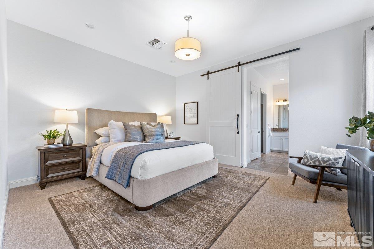 9815 Sea Bird Lane Reno, NV 89521 - Photo 14 of 40 a bedroom with a bed and a chandelier
