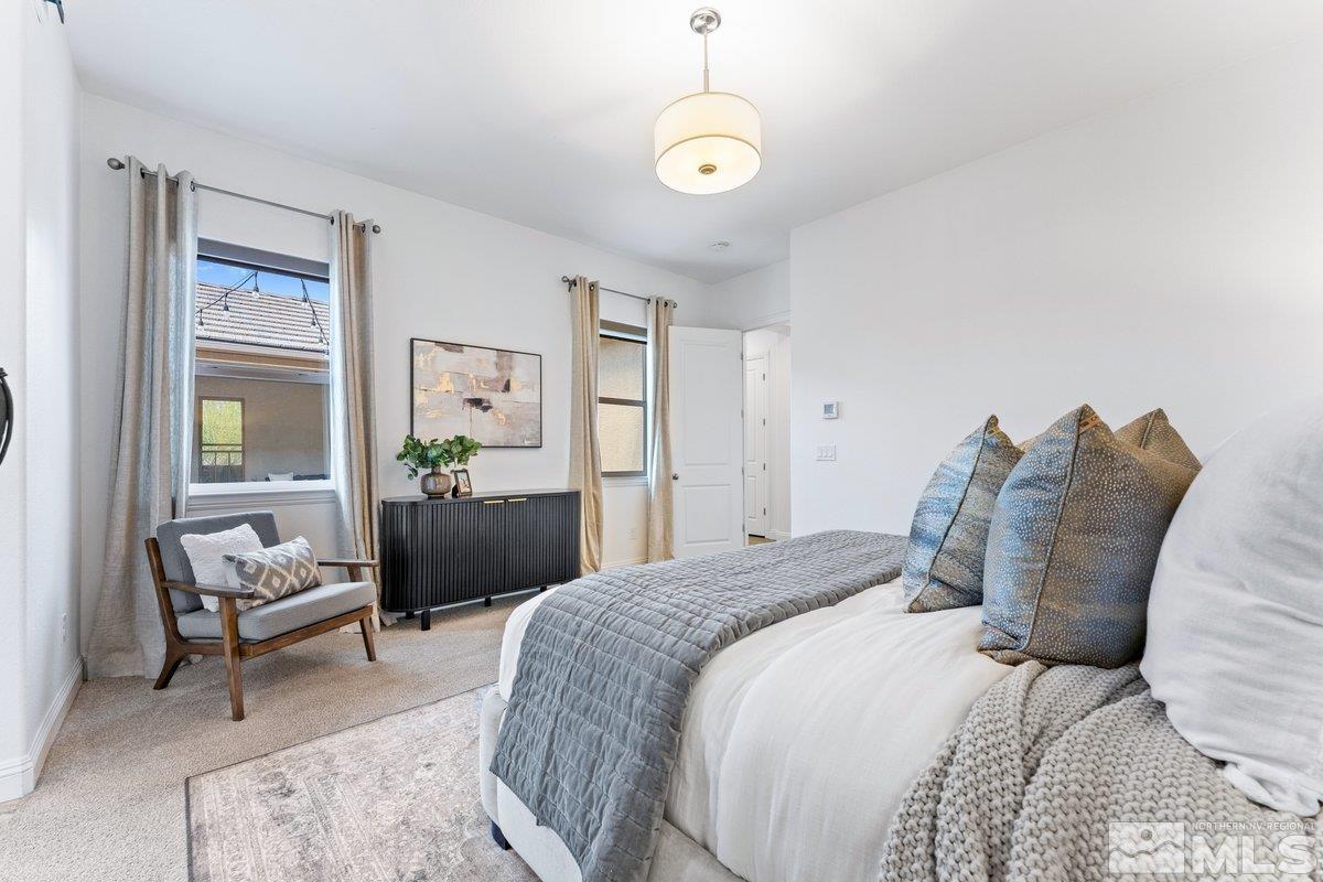 9815 Sea Bird Lane Reno, NV 89521 - Photo 15 of 40 a bedroom with a bed and a chandelier