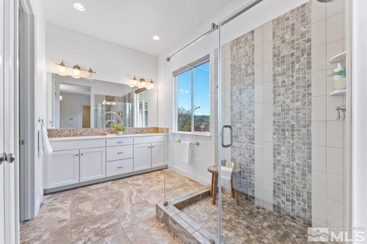 9815 Sea Bird Lane Reno, NV 89521 - Photo 16 of 40 a spacious bathroom with a granite countertop sink a toilet and a shower