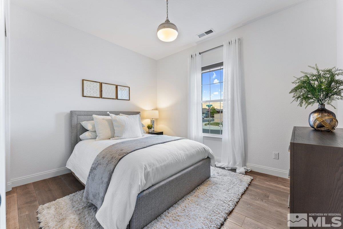 9815 Sea Bird Lane Reno, NV 89521 - Photo 18 of 40 a bedroom with a bed and a potted plant