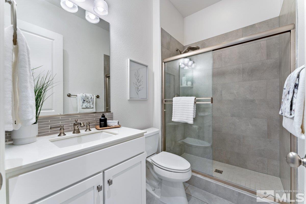 9815 Sea Bird Lane Reno, NV 89521 - Photo 19 of 40 a bathroom with a sink a toilet and shower