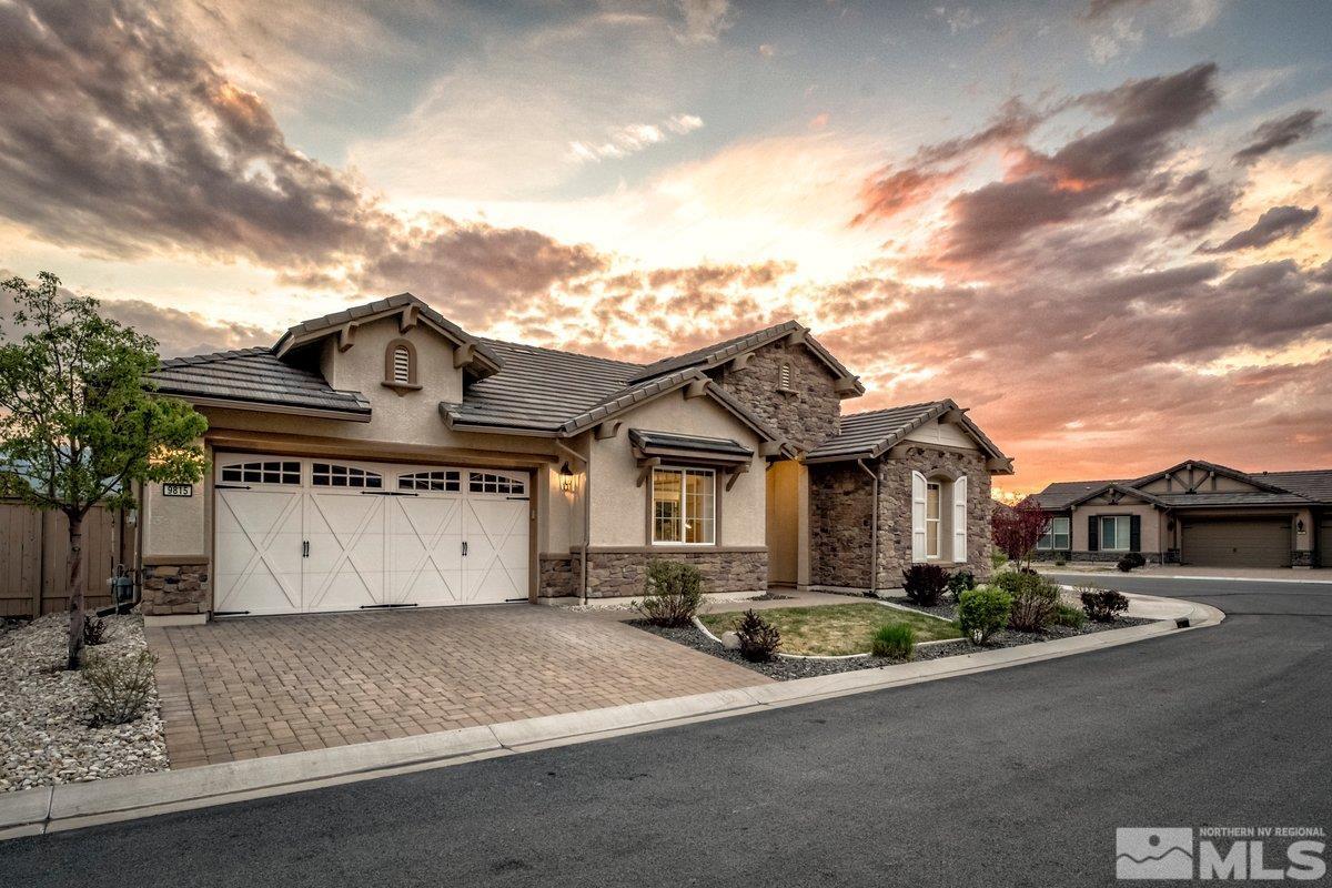 9815 Sea Bird Lane Reno, NV 89521 - Photo 2 of 40 a front view of a house with a yard and garage