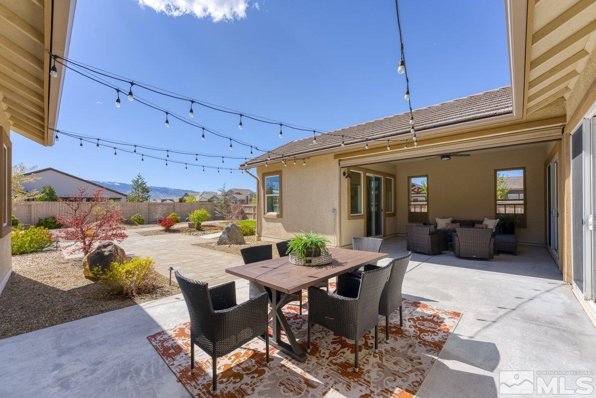 9815 Sea Bird Lane Reno, NV 89521 - Photo 24 of 40 a view of a patio with table and chairs and potted plants