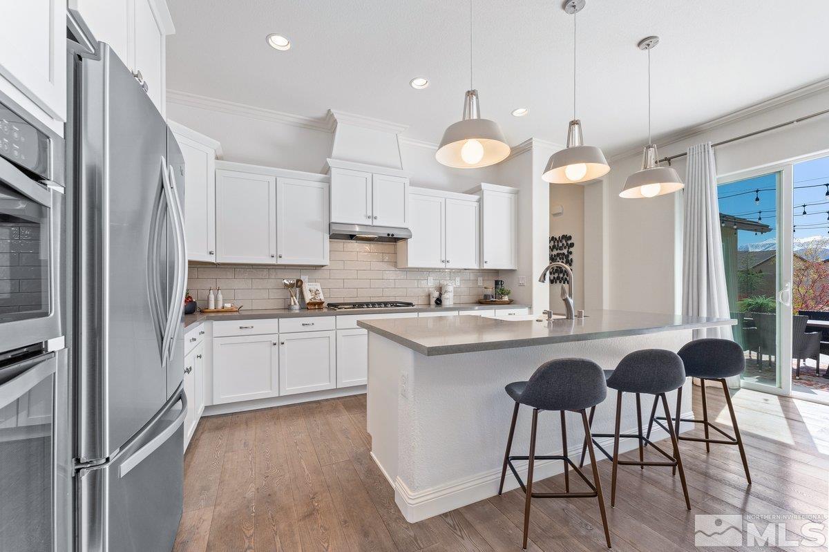 9815 Sea Bird Lane Reno, NV 89521 - Photo 10 of 40 a kitchen with granite countertop a sink a center island and cabinets