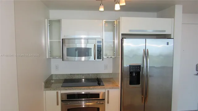 a kitchen with a refrigerator and a stove