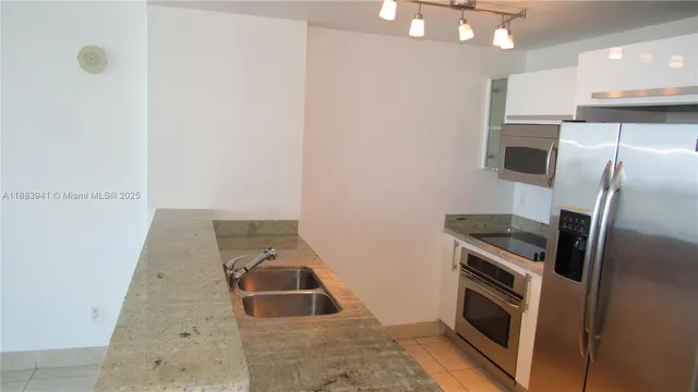 a kitchen with a sink and stainless steel appliances