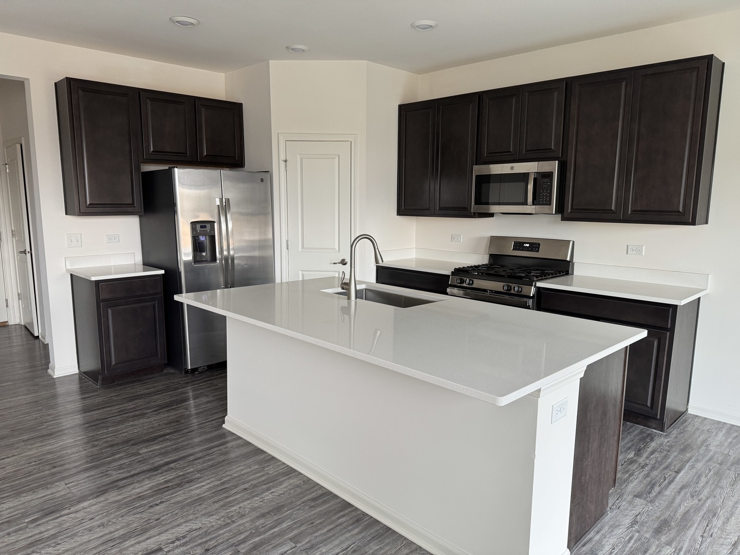 1209 Draper Road McHenry, IL 60050 - Photo 3 of 16 a kitchen with stainless steel appliances a sink a stove a microwave and cabinets