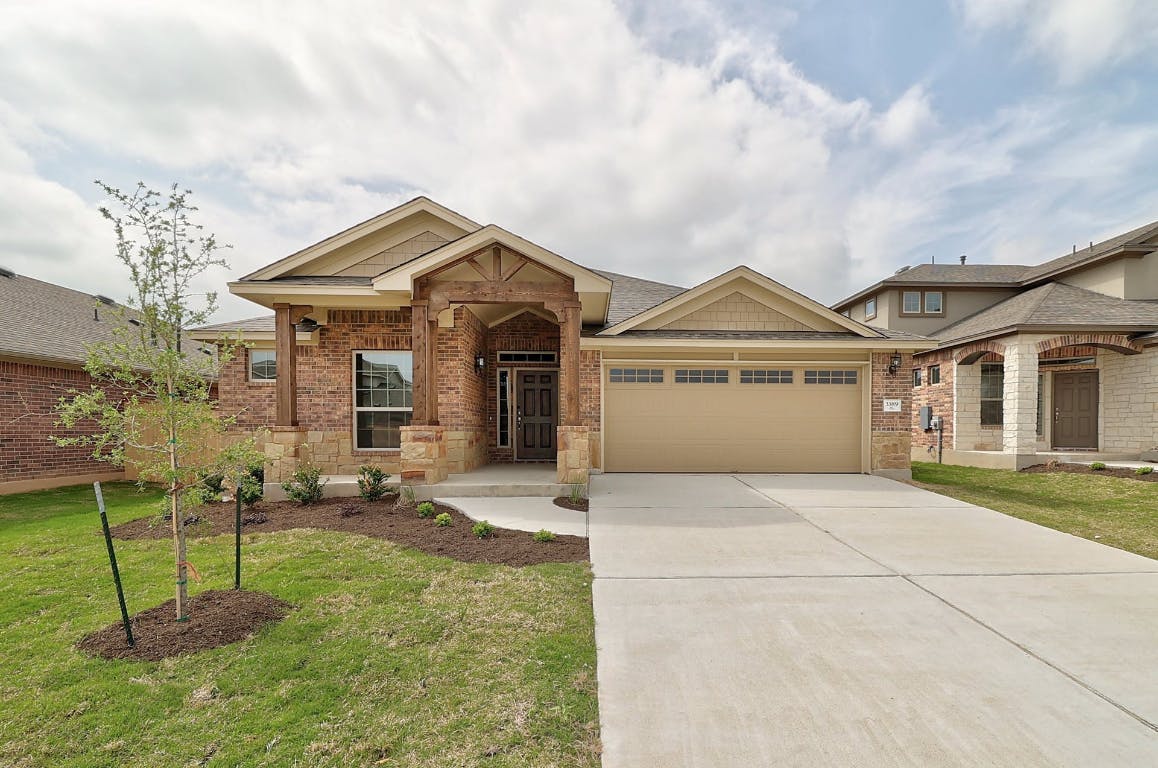 3389 Pauling Loop Round Rock, TX 78665 - Photo 1 of 37 a front view of a house with a yard and garage