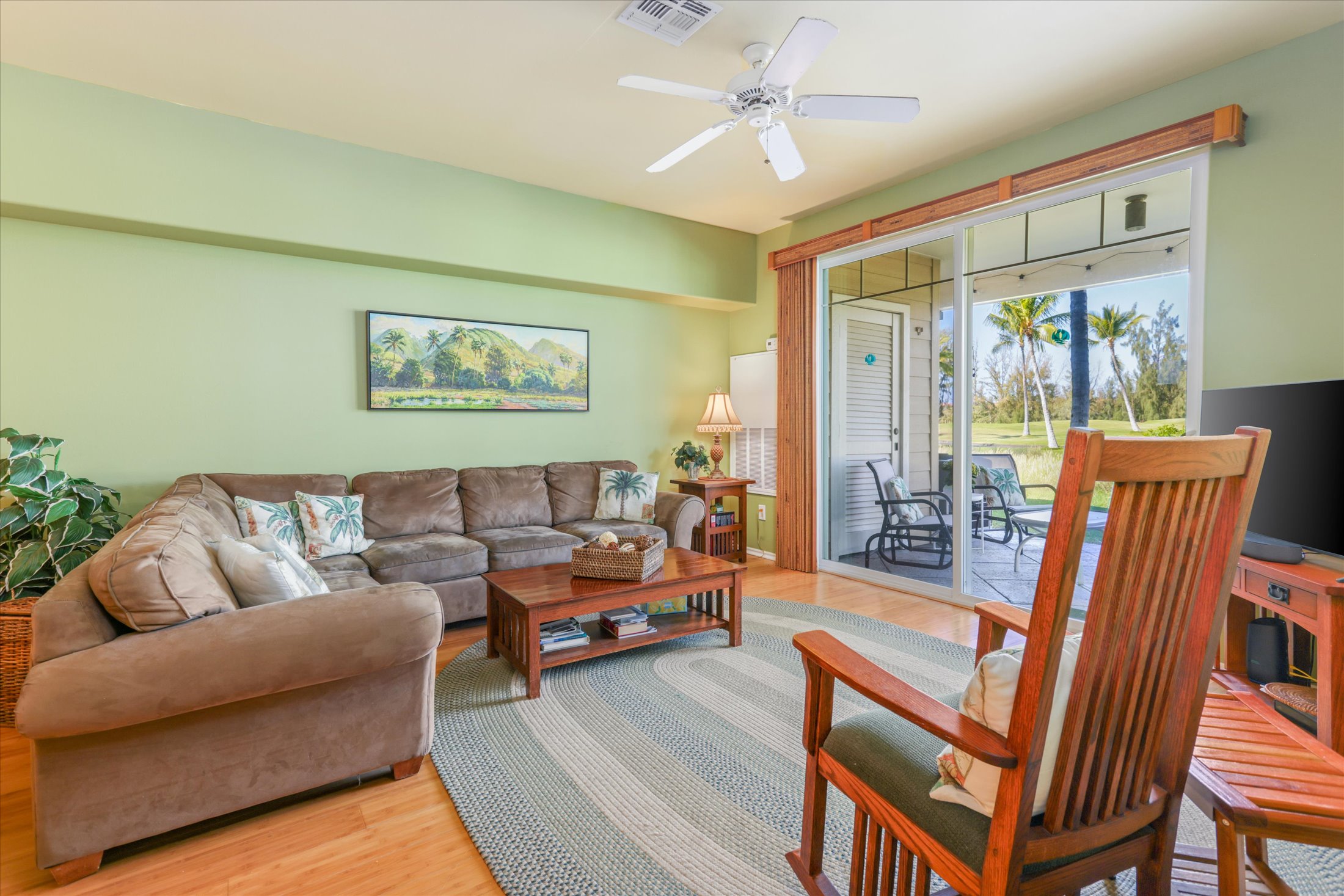 69-200 Pohakulana Place, Unit G5 Waikoloa, HI 96738 - Photo 1 of 27 a living room with furniture a ceiling fan and a large window