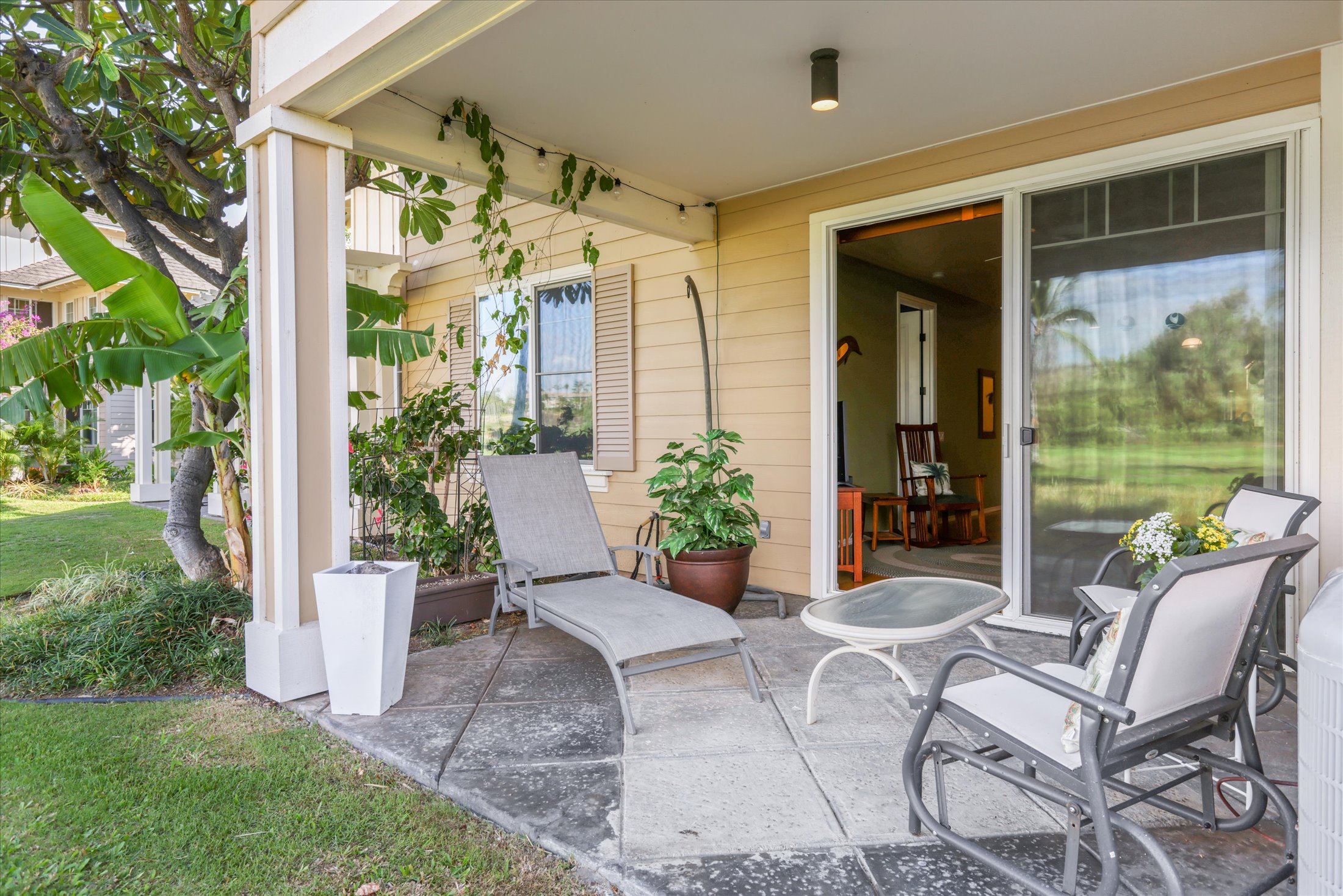 69-200 Pohakulana Place, Unit G5 Waikoloa, HI 96738 - Photo 12 of 27 a view of a chair and table in backyard of the house