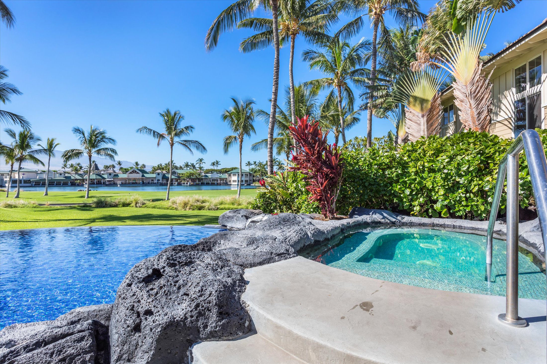 69-200 Pohakulana Place, Unit G5 Waikoloa, HI 96738 - Photo 21 of 27 a view of a swimming pool with a yard and palm trees