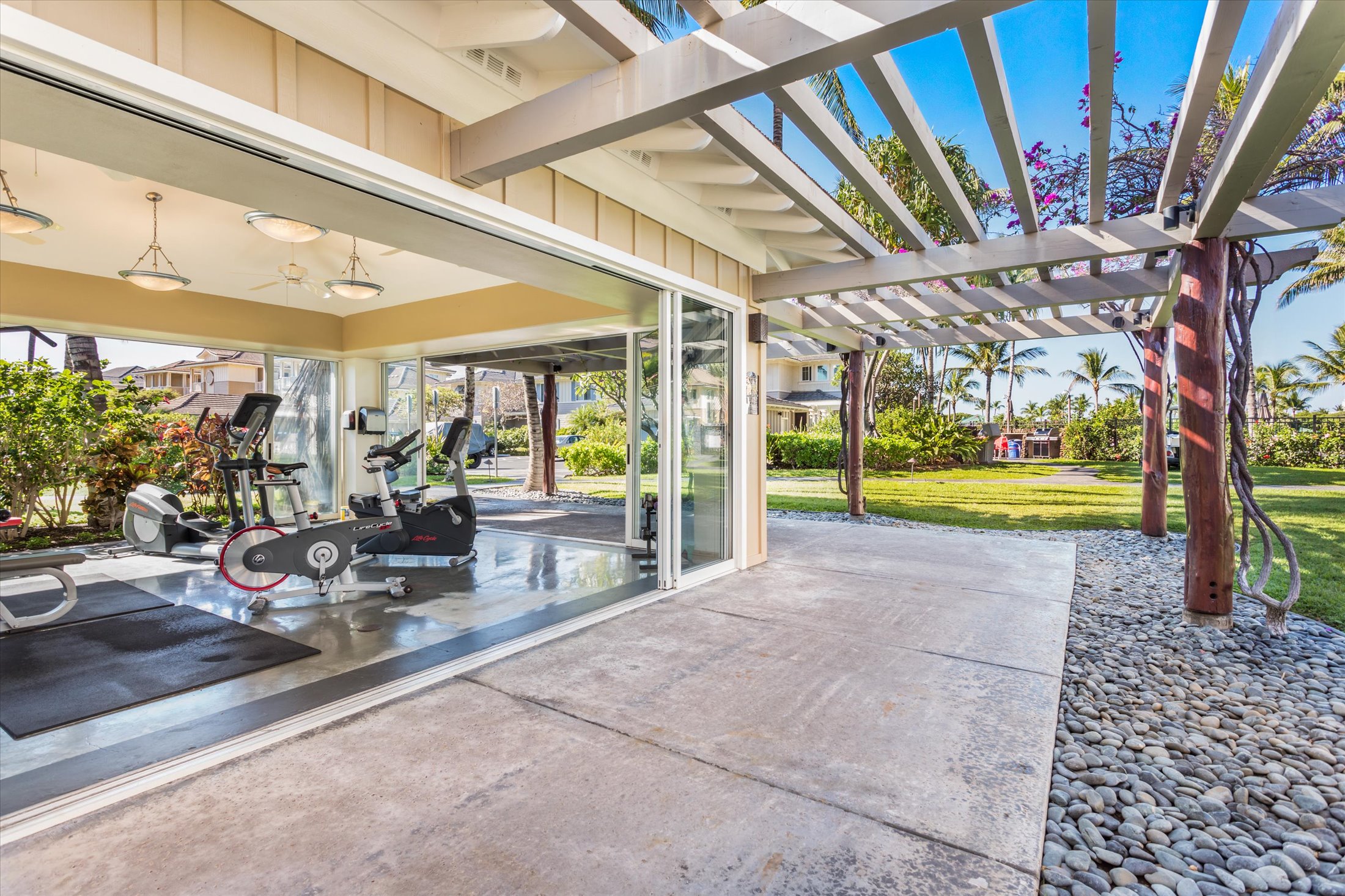 69-200 Pohakulana Place, Unit G5 Waikoloa, HI 96738 - Photo 25 of 27 a view of a patio with table and chairs potted plants and large tree