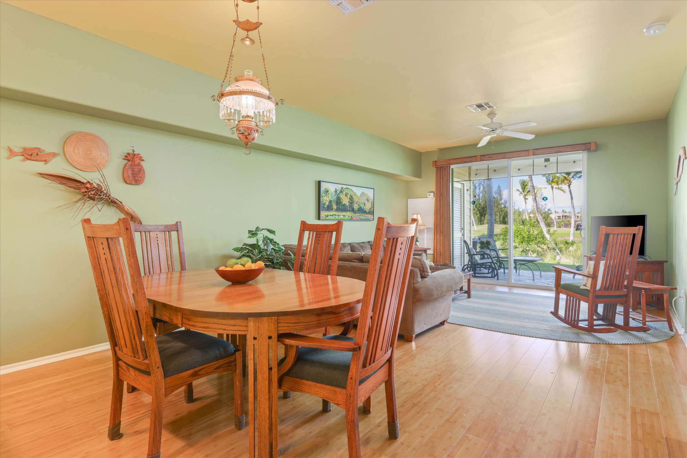 69-200 Pohakulana Place, Unit G5 Waikoloa, HI 96738 - Photo 8 of 27 a dining room with furniture a chandelier and wooden floor