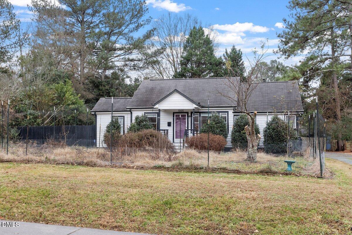 1005 West Main Street Carrboro, NC 27510 - Photo 1 of 27 a view of a house with backyard and a tree