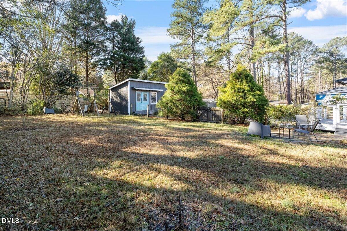 1005 West Main Street Carrboro, NC 27510 - Photo 24 of 27 a front view of a house with a yard and garage