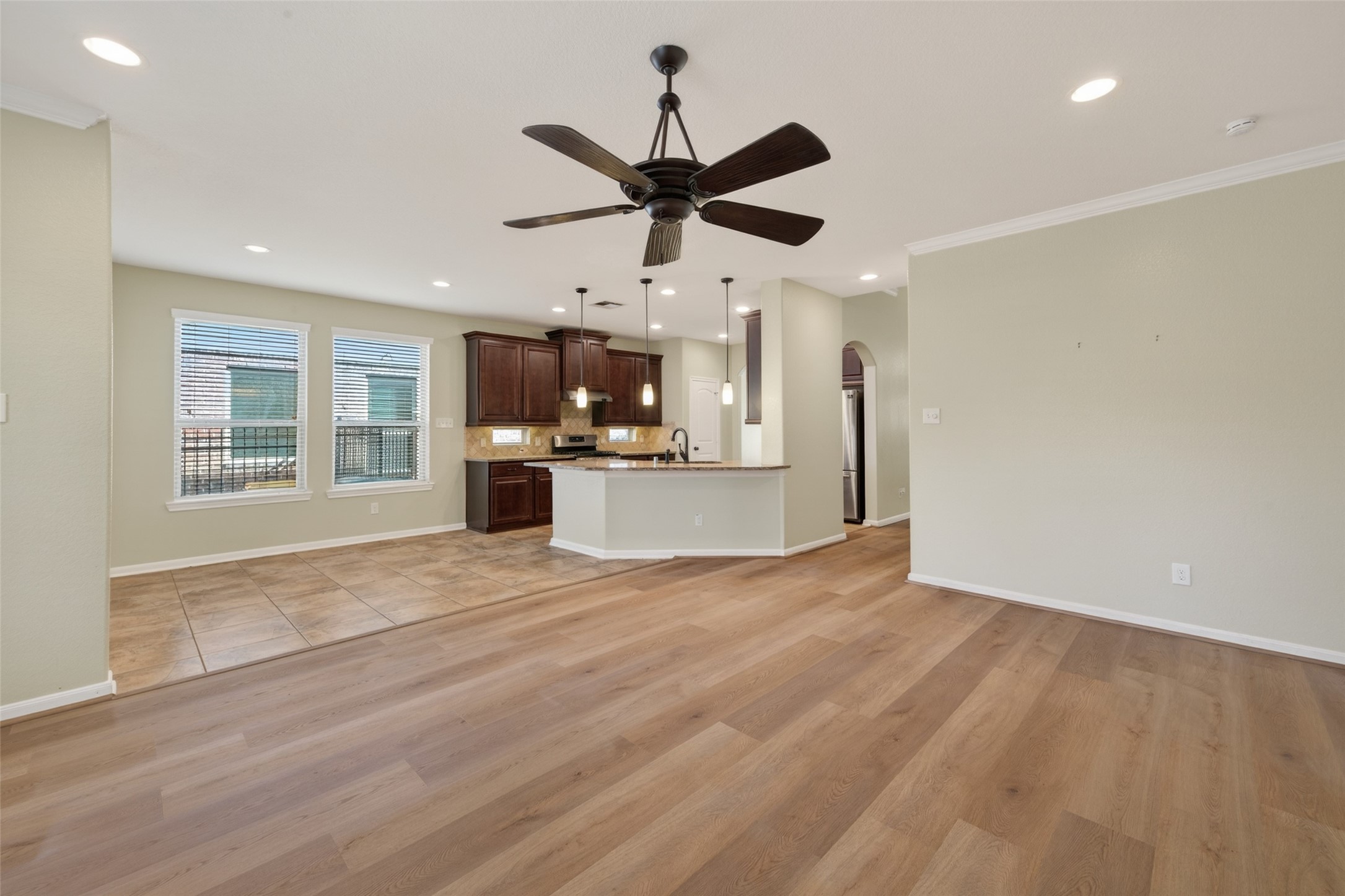 6 Painted Post Place Spring, TX 77389 - Photo 12 of 49 a view of empty room with a kitchen and fireplace