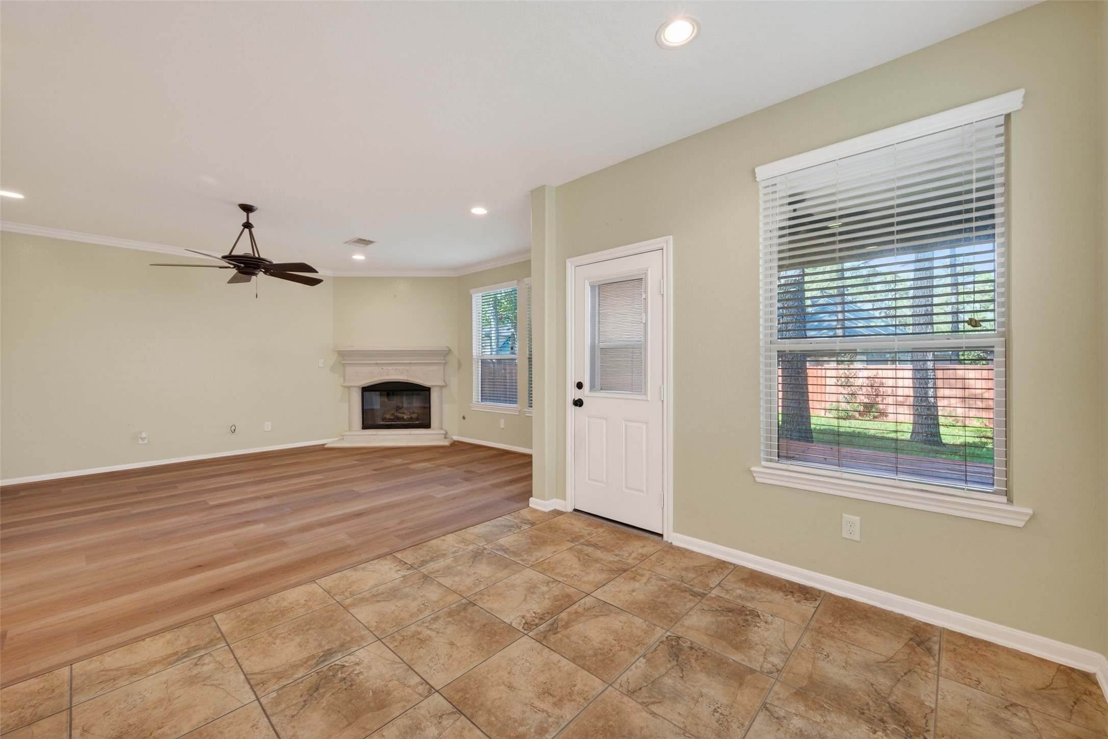 6 Painted Post Place Spring, TX 77389 - Photo 14 of 49 a view of livingroom with a fireplace a ceiling fan and window