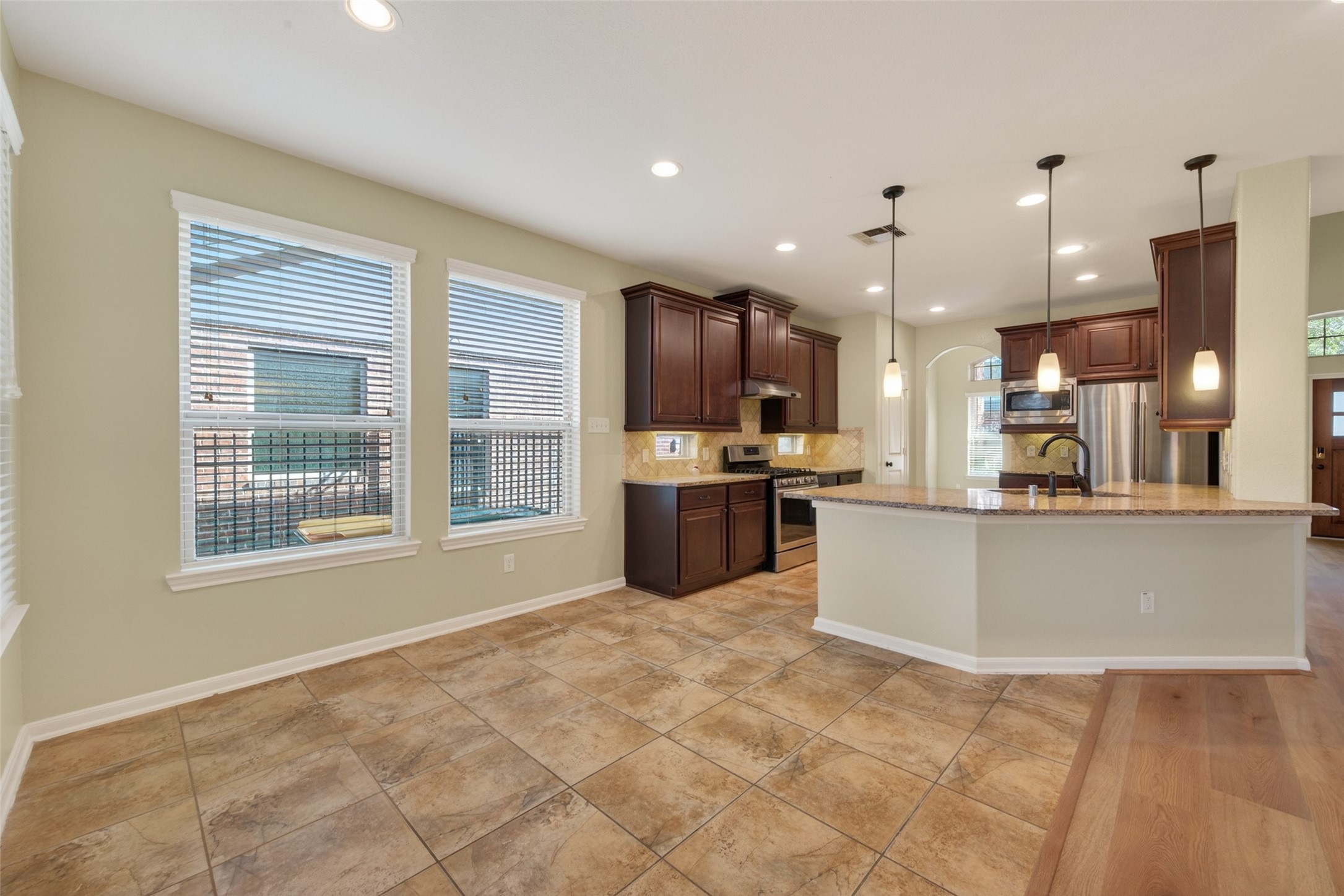 6 Painted Post Place Spring, TX 77389 - Photo 16 of 49 a large kitchen with a large counter top stainless steel appliances and cabinets