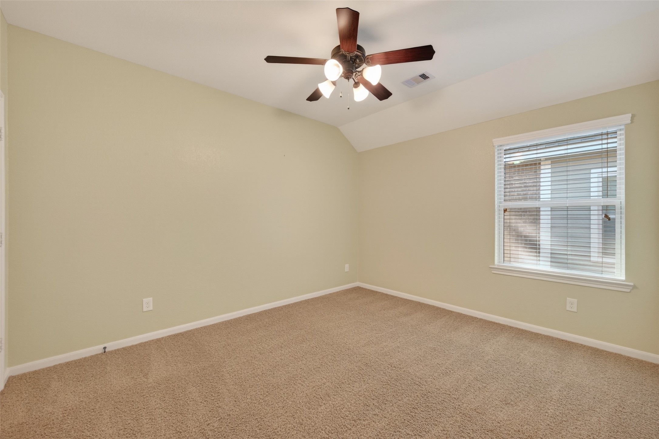 6 Painted Post Place Spring, TX 77389 - Photo 30 of 49 an empty room with a chandelier fan and windows