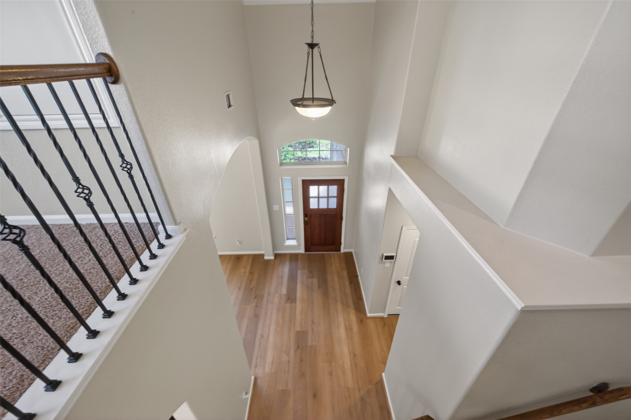 6 Painted Post Place Spring, TX 77389 - Photo 45 of 49 a view of a hallway with wooden floor and staircase