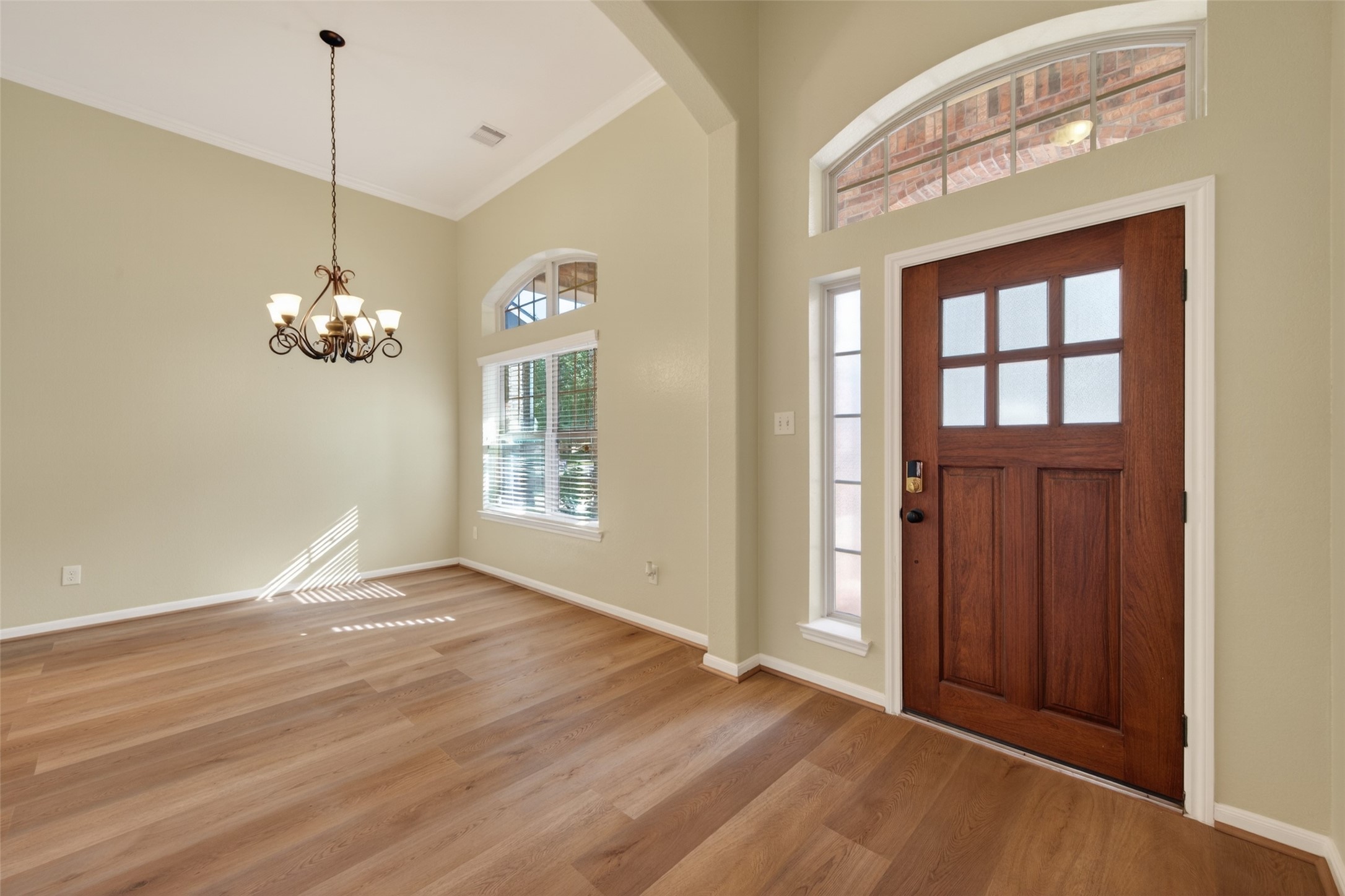 6 Painted Post Place Spring, TX 77389 - Photo 6 of 49 a view of a room with wooden floor and chandelier
