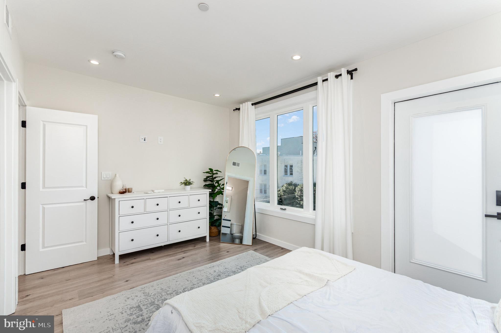 2116 4th Street Northeast, Unit A Washington, DC 20002 - Photo 8 of 17 a bedroom with a bed and a dresser