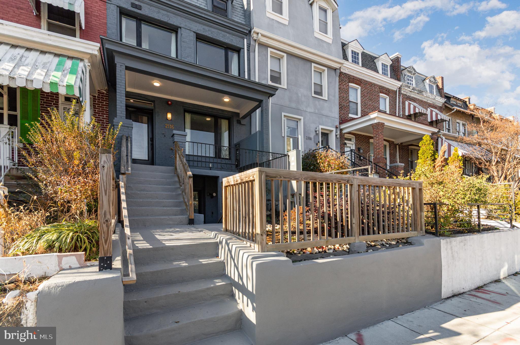 2116 4th Street Northeast, Unit A Washington, DC 20002 - Photo 13 of 17 a view of a brick house with large windows and a small yard