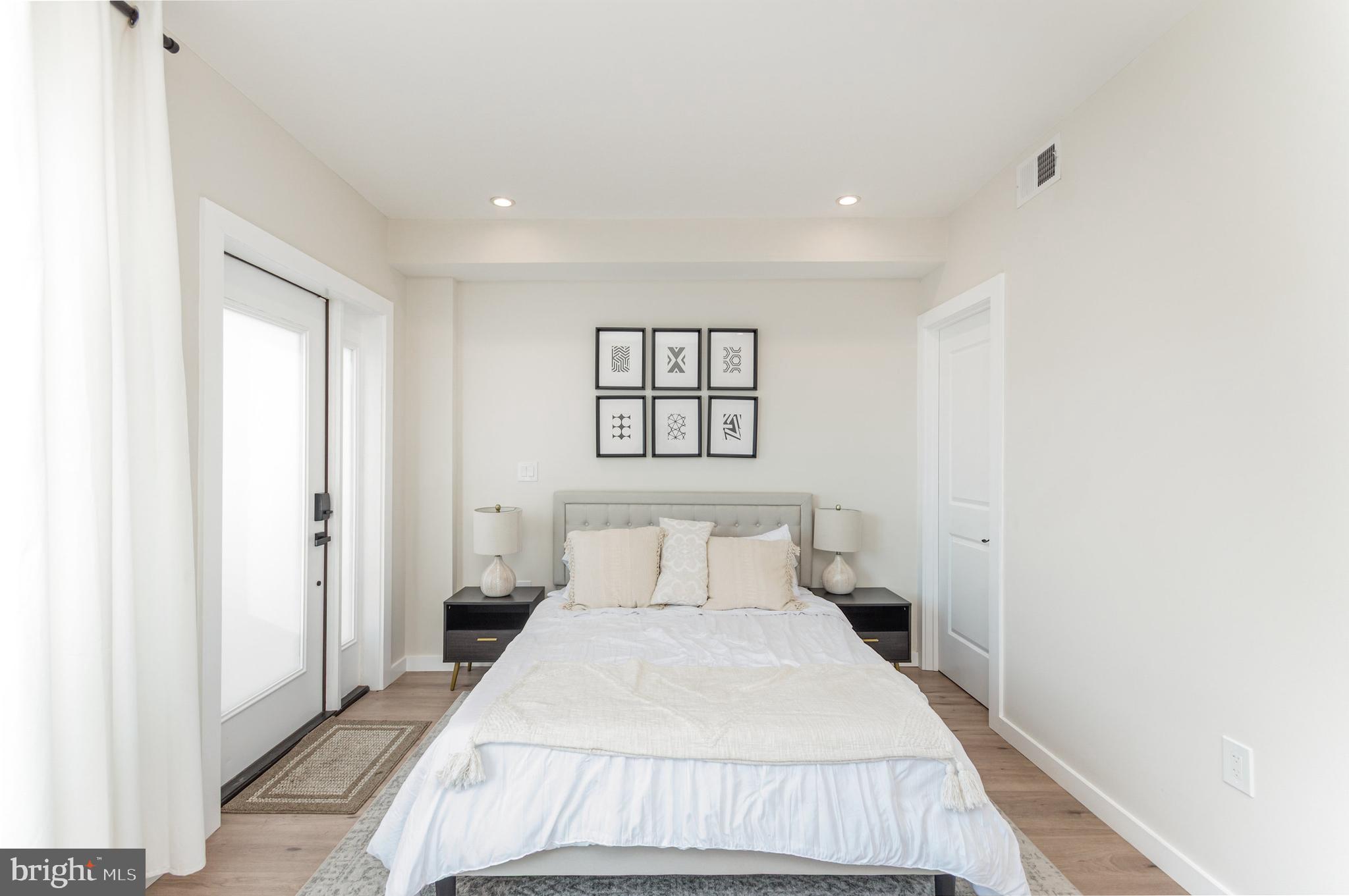 2116 4th Street Northeast, Unit A Washington, DC 20002 - Photo 6 of 17 a bedroom with a bed and a painting