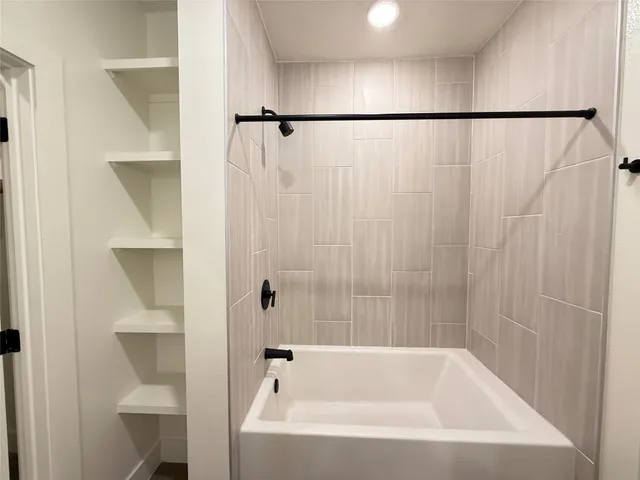 a bathroom with a bathtub and a shower