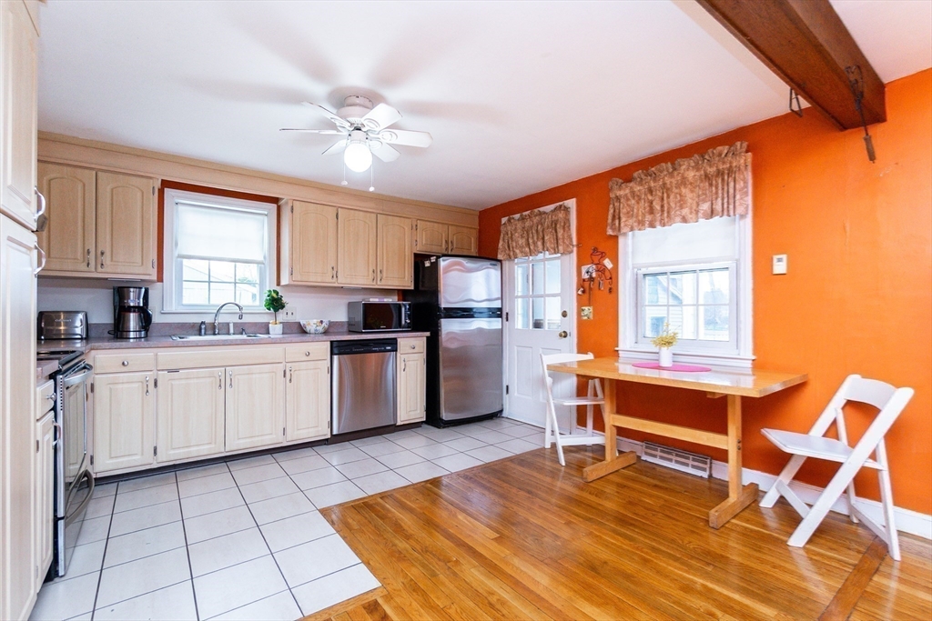 16 Birch Road Framingham, MA 01701 - Photo 13 of 39 a kitchen with stainless steel appliances a stove a sink cabinets and a window