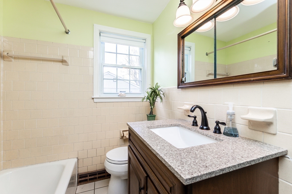 16 Birch Road Framingham, MA 01701 - Photo 9 of 39 a bathroom with a granite countertop sink and a toilet