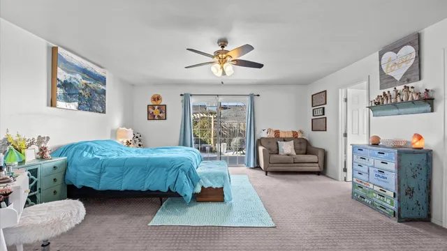 a bedroom with a bed and ceiling fan