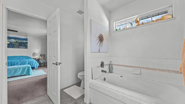 a bathroom with a tub and shower