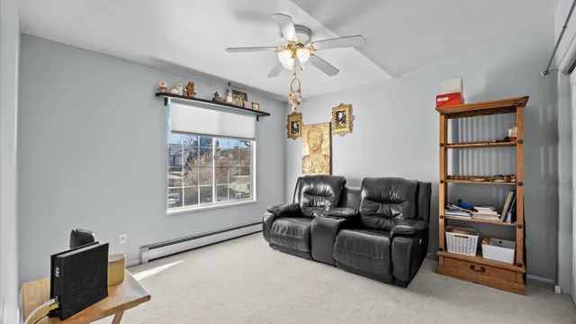 a living room with furniture a window and a flat screen tv