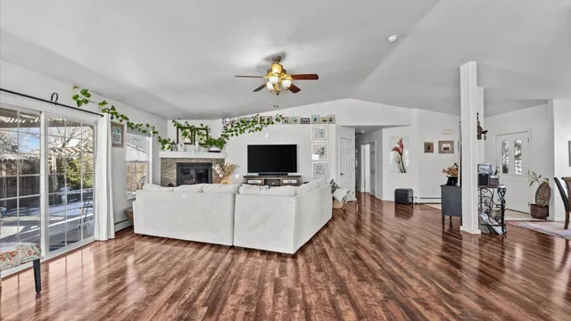 a living room with furniture a flat screen tv and a fireplace