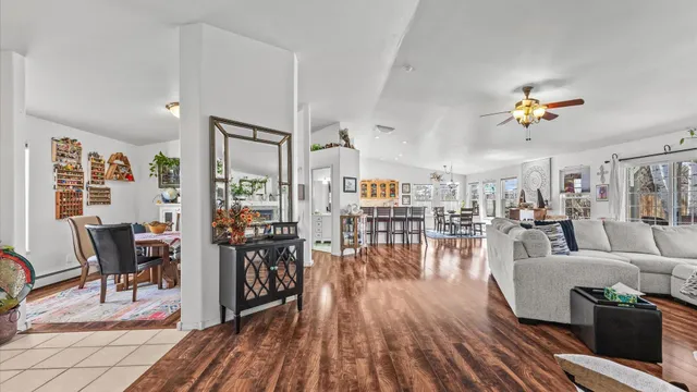 a living room with lots of furniture and wooden floor