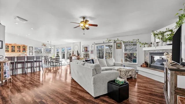 a living room with furniture a fireplace and a flat screen tv