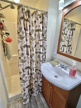 a bathroom with a sink and a shower curtain